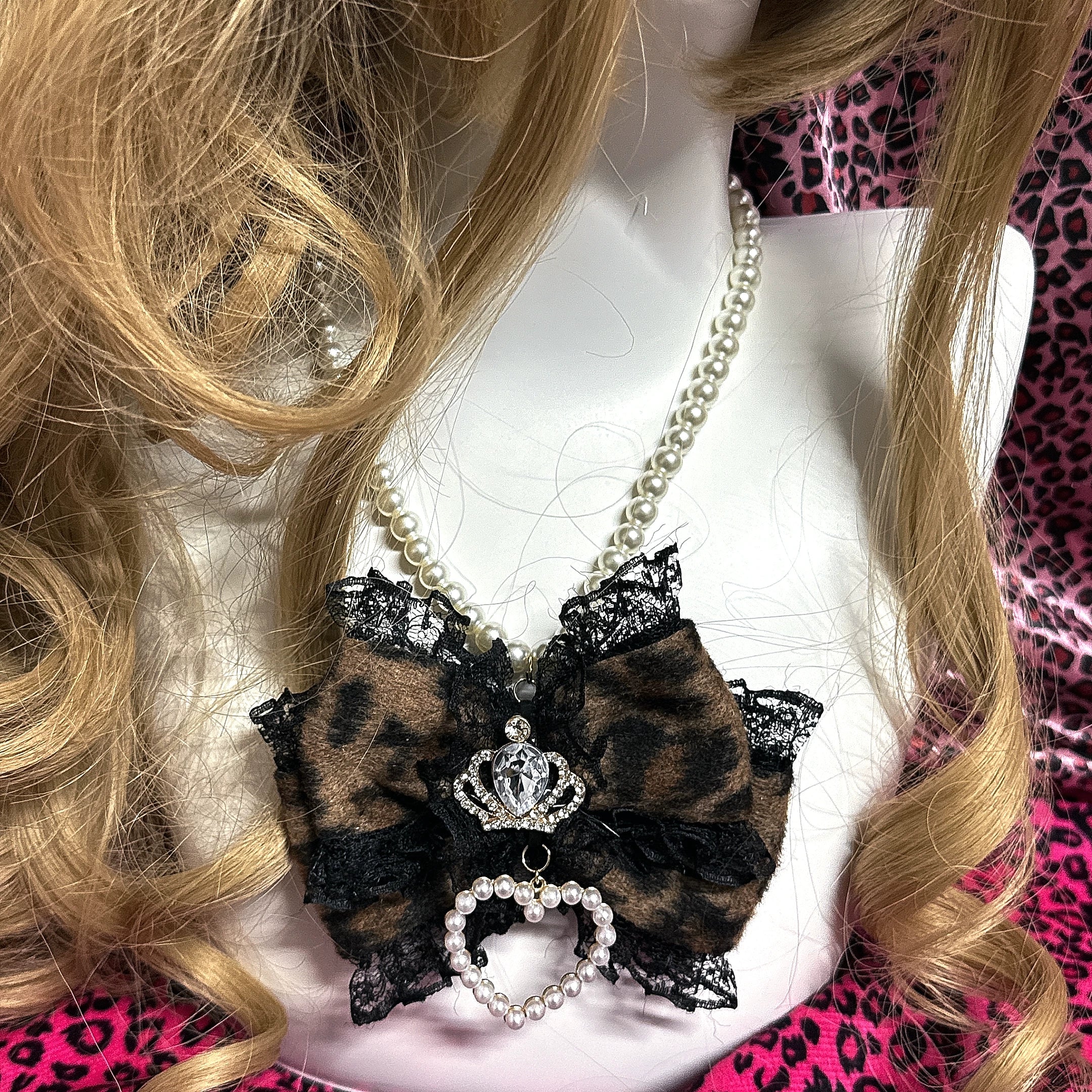 Brown leopard bow pearl choker with lace trim crown rhinestone and pearl heart charm front view on mannequin