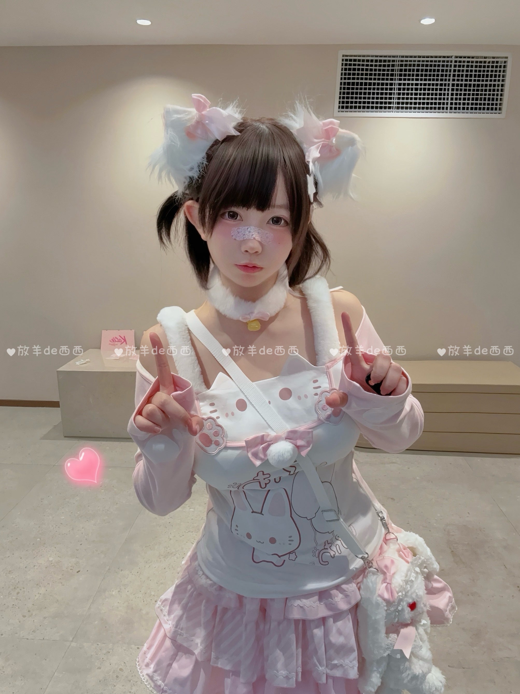 Kawaii Jirai Kei lolita outfit featuring cat-print off-shoulder top with white fuzzy choker and crossbody plush animal bag, front full-body indoor shot with twin pom-pom hair clips and bunny print coordination