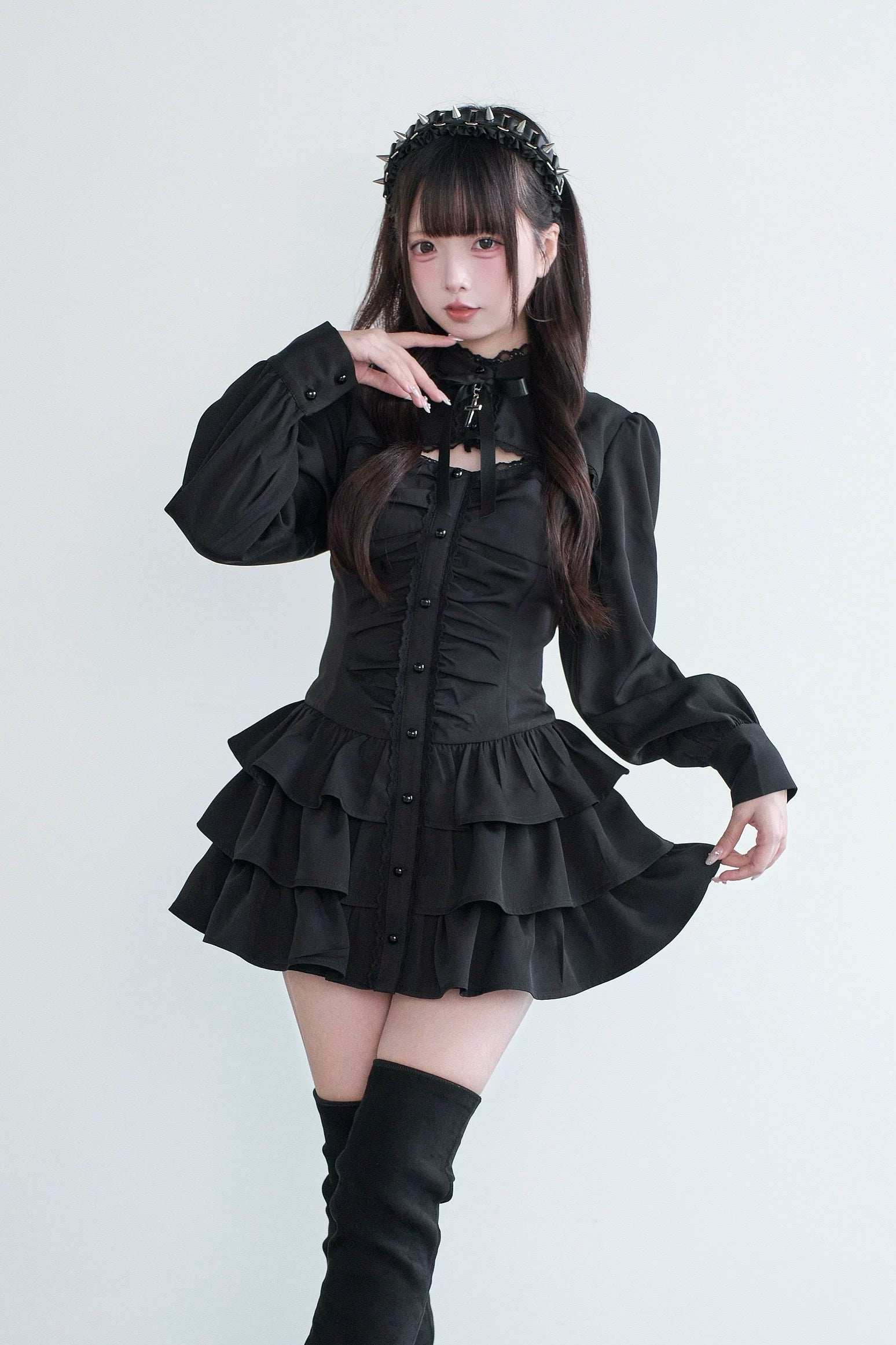 Black Jirai Kei lace-up gothic dress with tiered ruffled skirt and long puff sleeves front three-quarter view