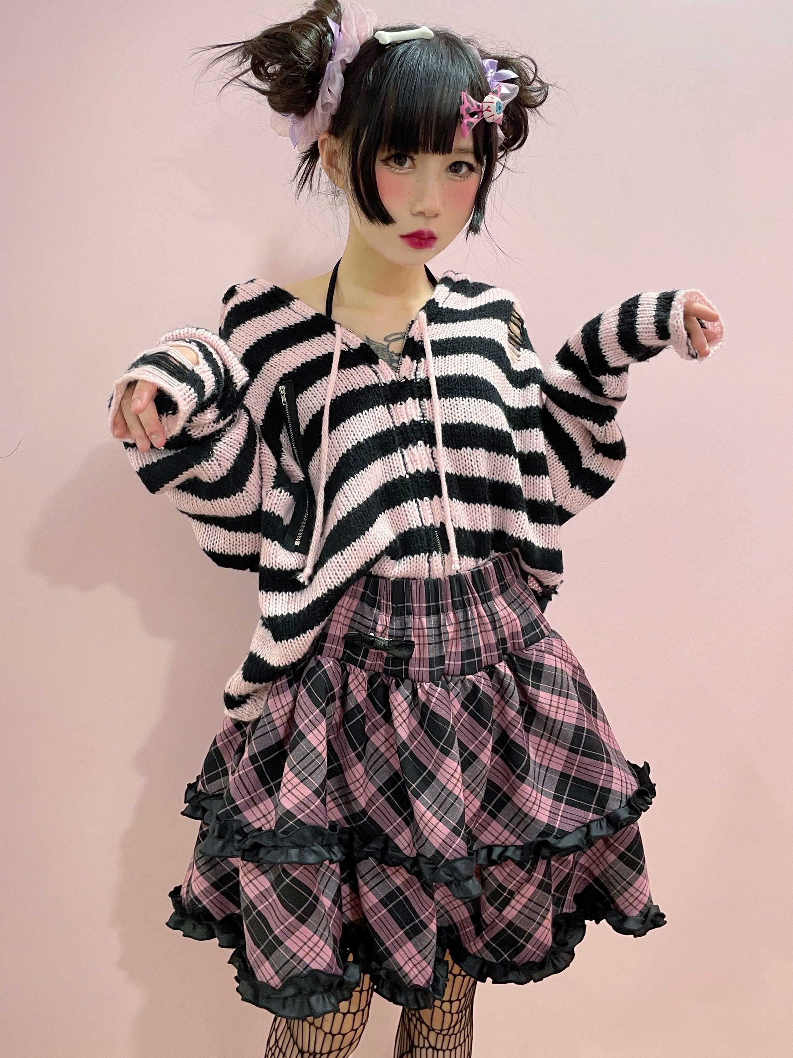 Pink-black plaid Jirai Kei ruffle mini skirt full-body outfit, layered ruffles with elastic waist, styled with twin buns and fishnet stockings