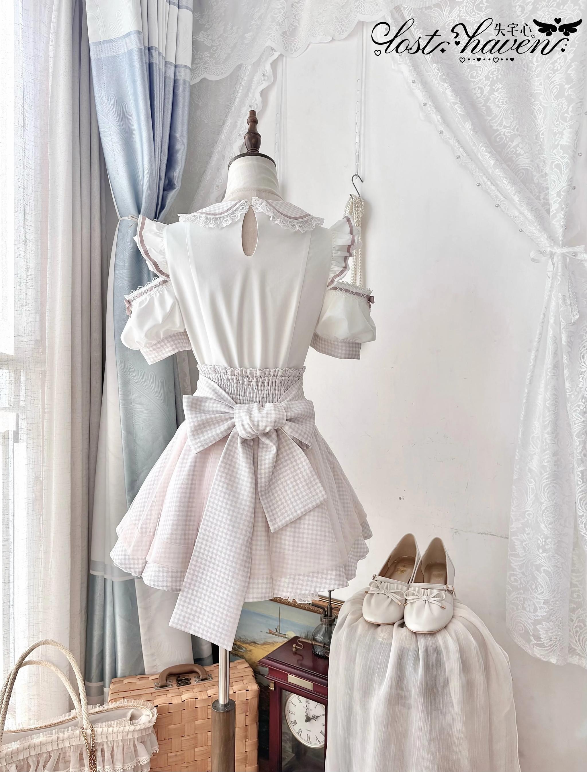 Back display view of Jirai Kei maid outfit showing solid off-white back design with hollow cutout details and prominent front decorative bow accent