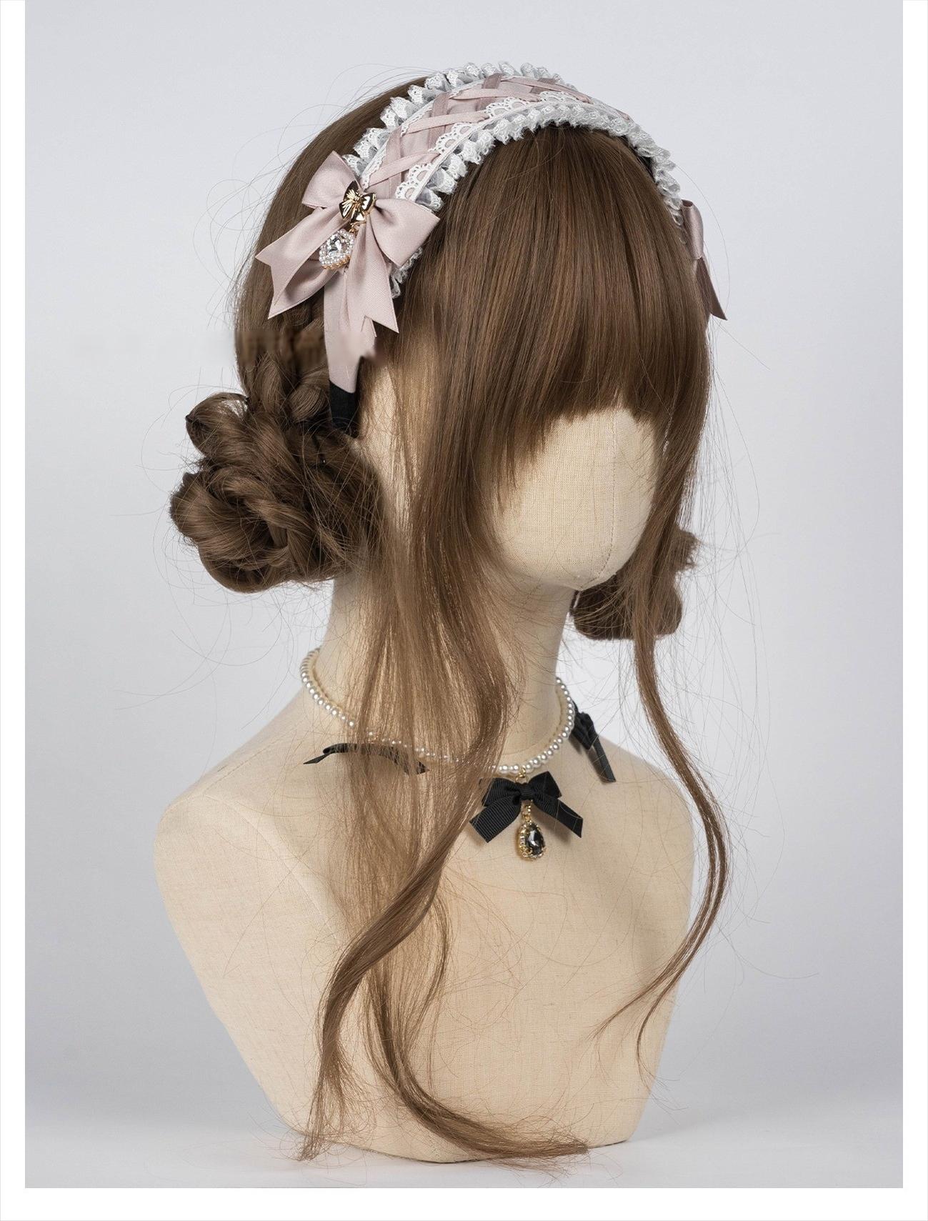 White-pink dusty rose Jirai Kei lace headband with ruffled lace and satin bow embellishments on mannequin with brown curly bun hairstyle, showcasing how headband pairs with varied hair styles