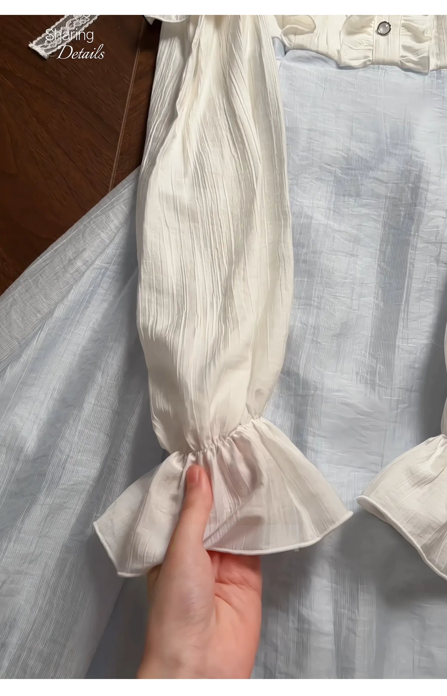 Seiso Kei dress sleeve detail showing flared puff sleeve, lace tie strap, and color-block fabric construction