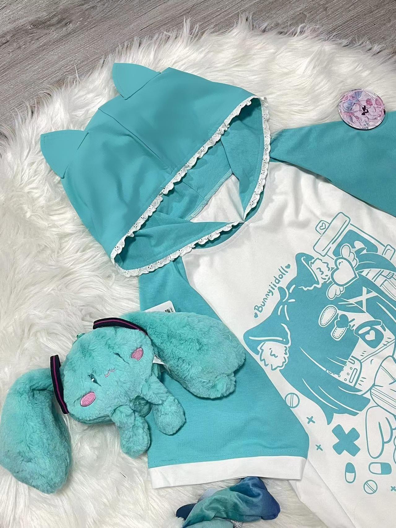 Green yami kawaii cat ear hooded anime graphic tee loose fit raglan sleeve featuring symbolic anime print with pills crosses and IV bags, jirai kei subculture fashion piece