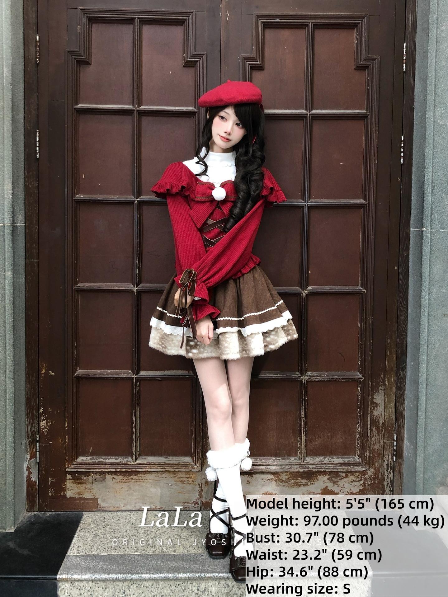 Full body front shot of complete jirai kei christmas ensemble with matching red beret, white frilly socks, and black leather shoes against wooden door background