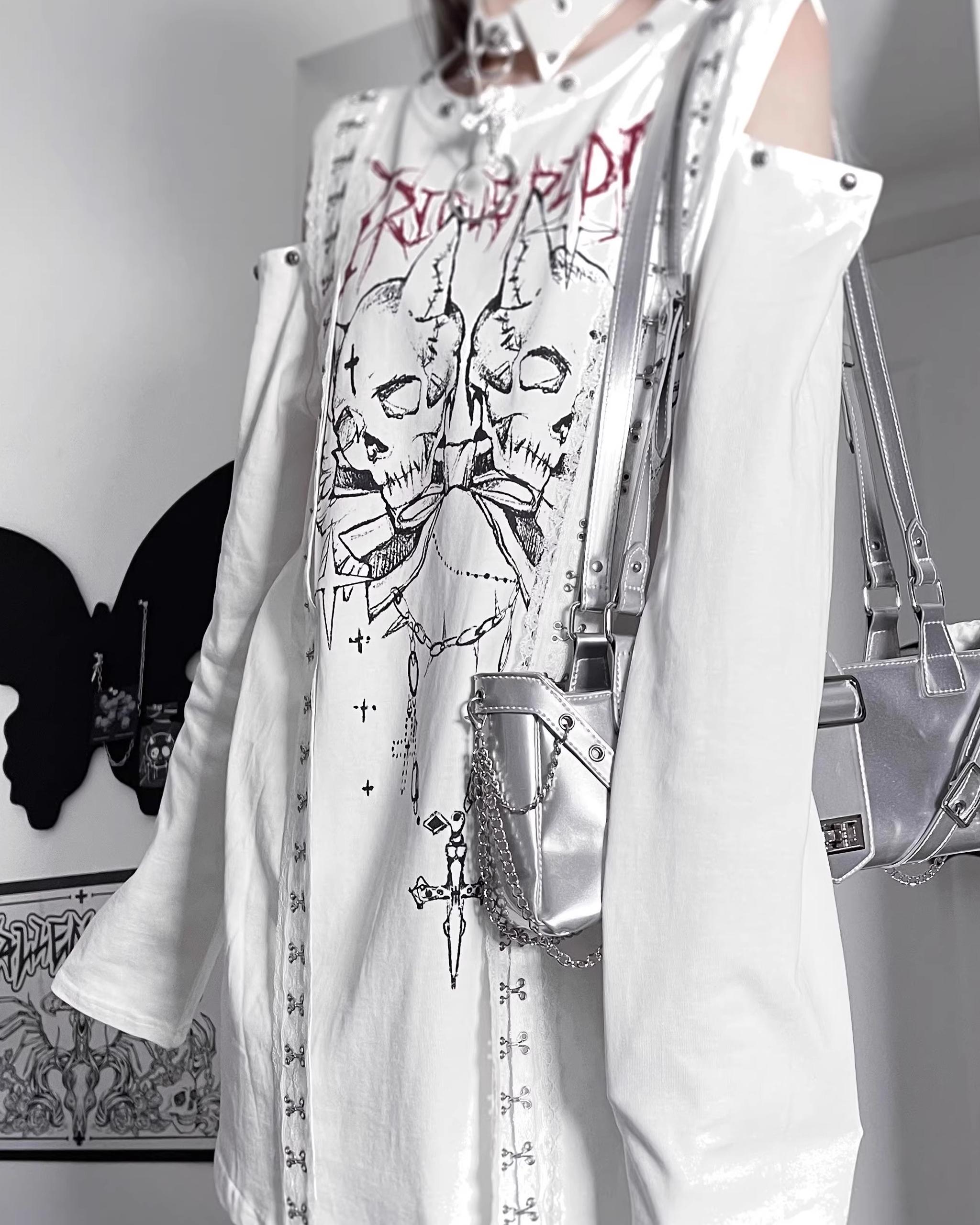 White cold-shoulder dual skull gothic print t-shirt front close-up showing cross strap trims and cut-out shoulders