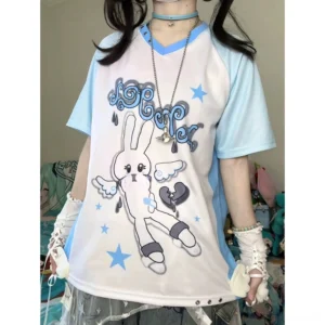 Close-up detail of angel bunny graphic print showing intricate celestial design with angel text and blue star elements on jersey fabric, layered necklace styling demonstrated