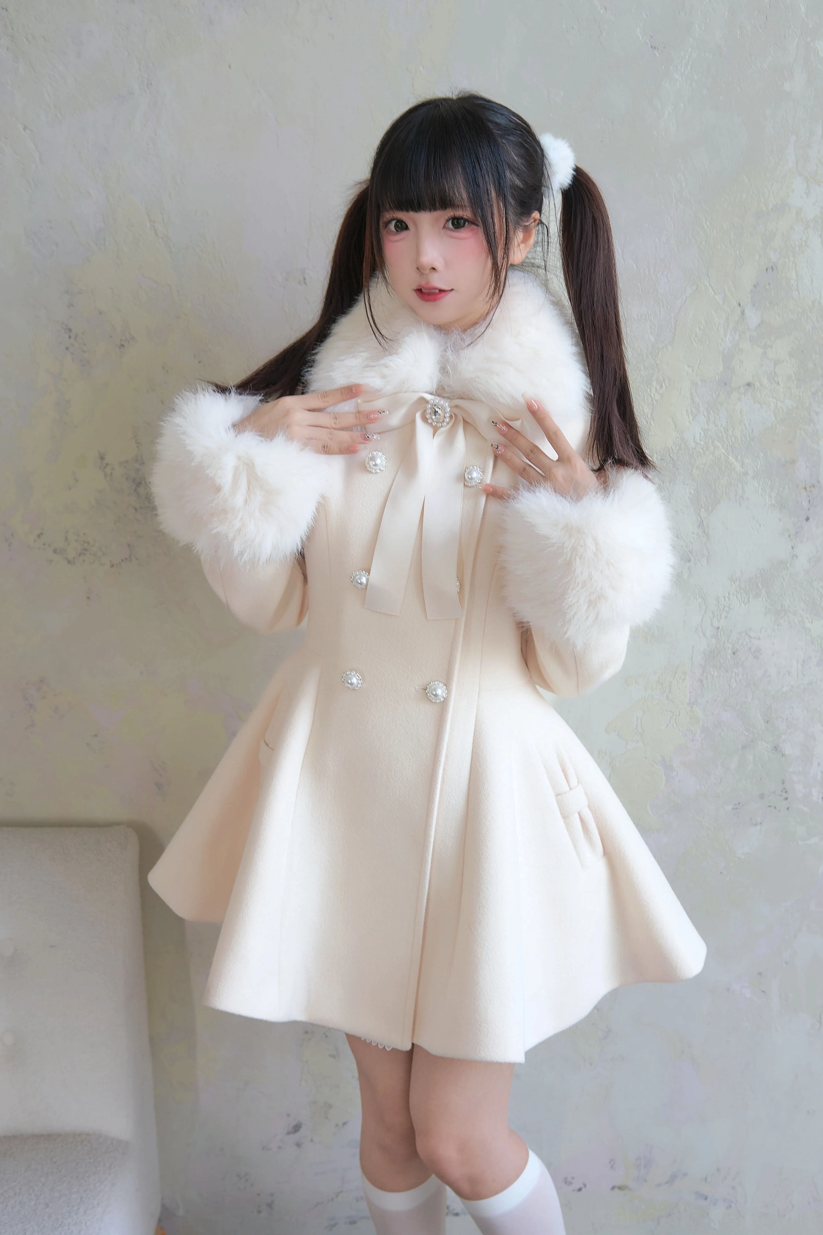 Apricot color Jirai Kei winter coat detail shot showcasing pearl buttons ribbon bow neck decoration and tweed fabric texture