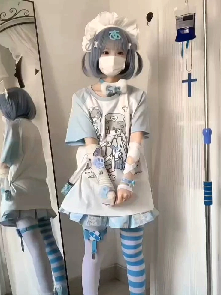 Alternate front pose of aqua and white tenshi nurse raglan showing clear cartoon nurse graphic on oversized fit t-shirt