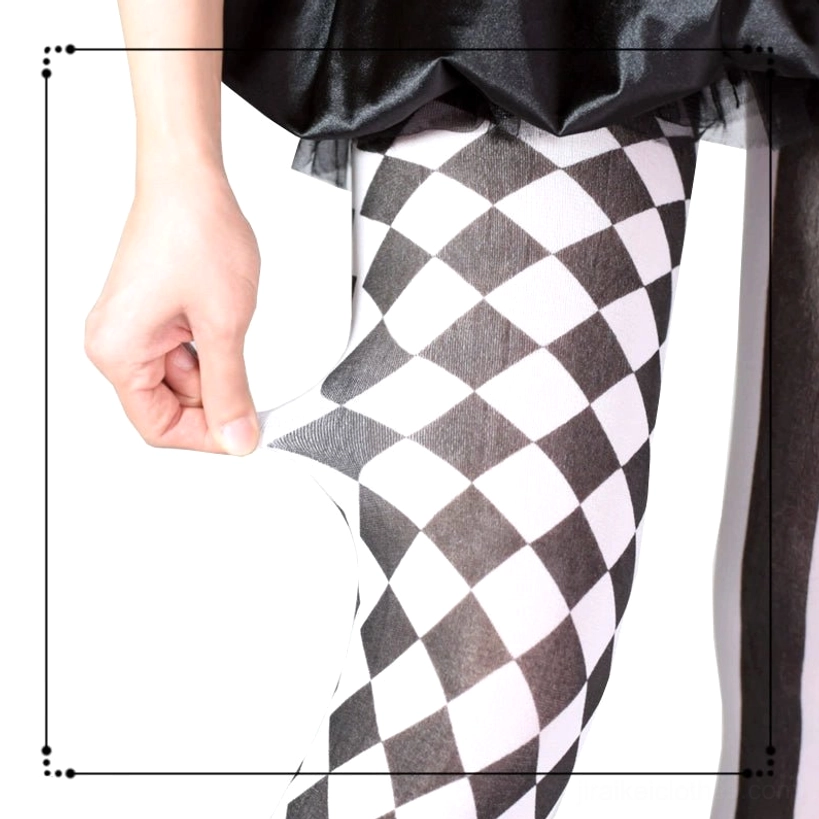 Hand stretching black and white asymmetric argyle stripe pantyhose to demonstrate elasticity and core-spun yarn quality, side close-up view