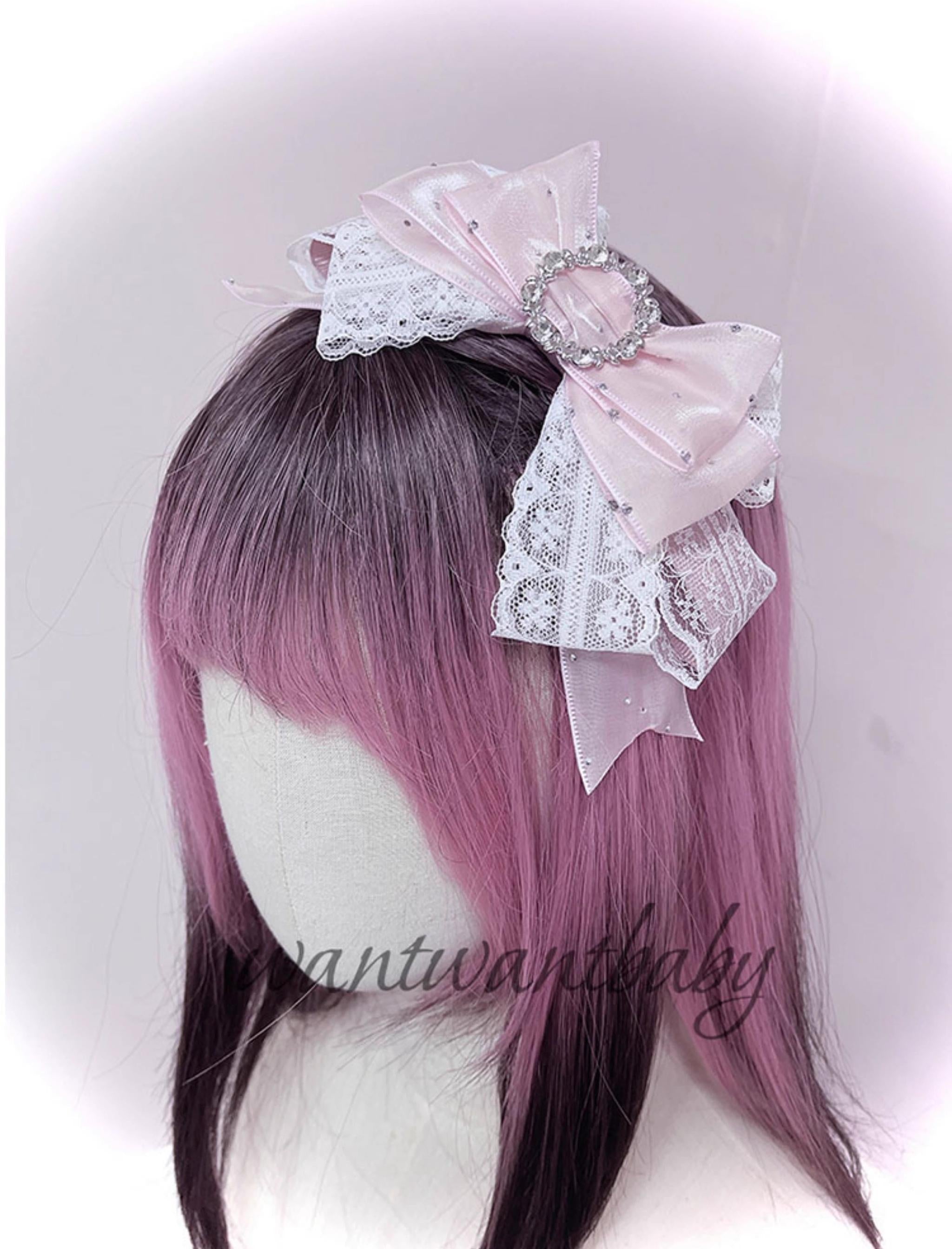 Pink satin ribbon bow jirai kei hair clip with white lace overlay and circular rhinestone decoration on wig mannequin