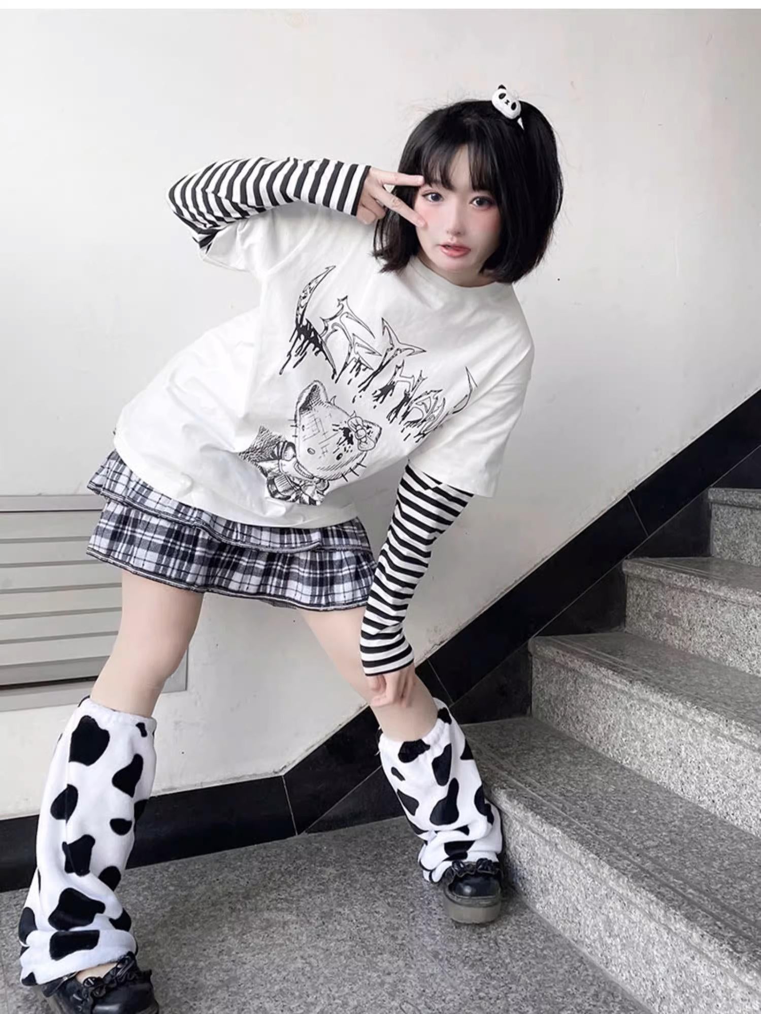 Close-up detail of striped sleeve construction on jirai kei fake two-piece long sleeve punk tee showing color blocking