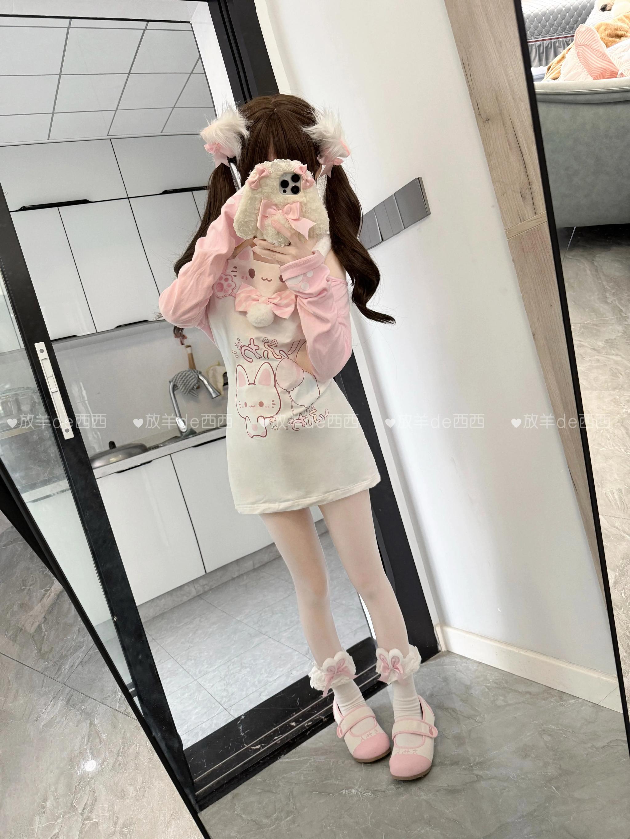 Kawaii cat-print tiered ruffled pink skirt with embroidered paw-print accents and elastic waistband, full-length standalone display shot highlighting multi-layer ruffle construction and silhouette