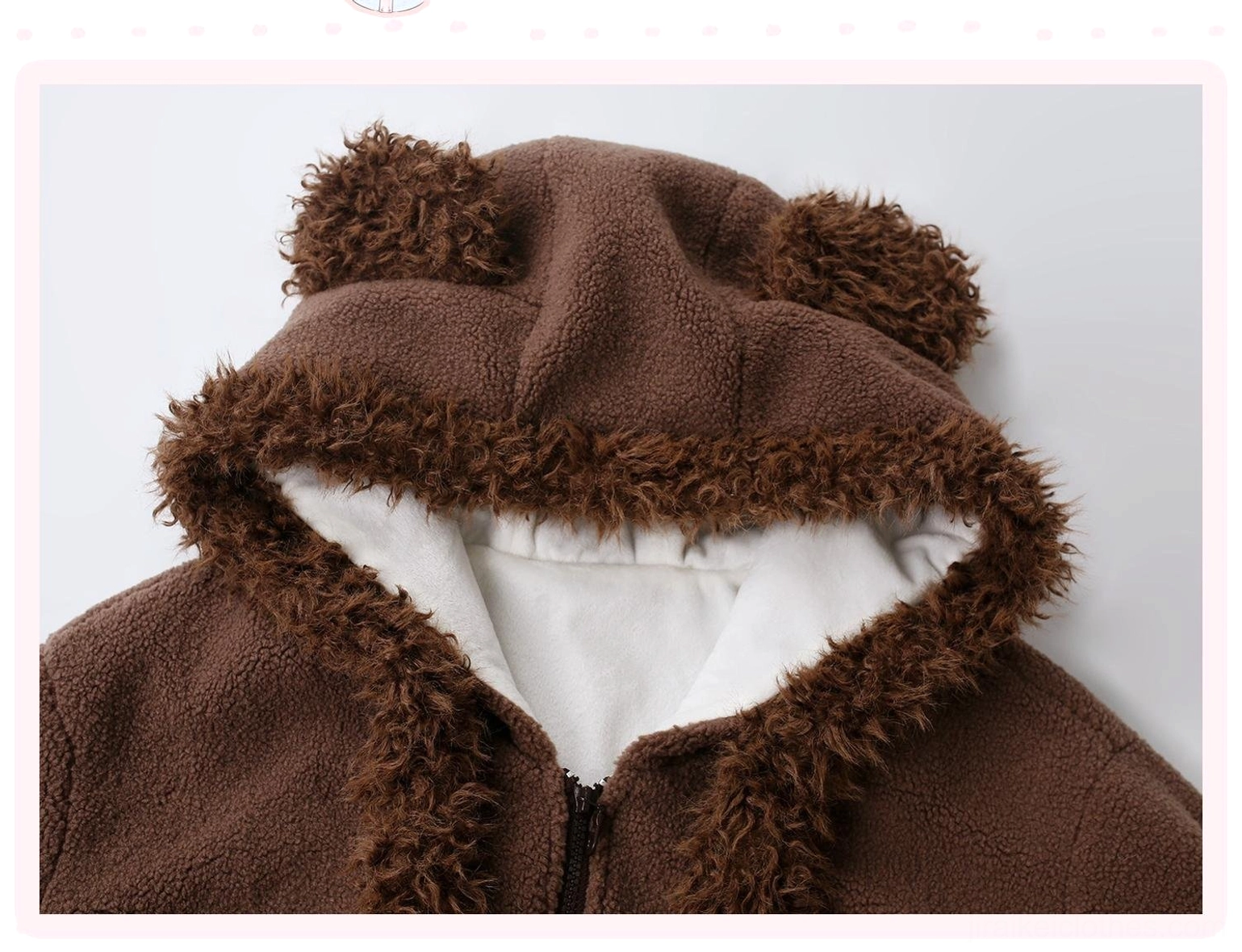 Top-down close-up detail shot of bear ear hood showing fuzzy brown exterior, adorable bear ears design, drawstring ties, and white inner fleece lining contrast