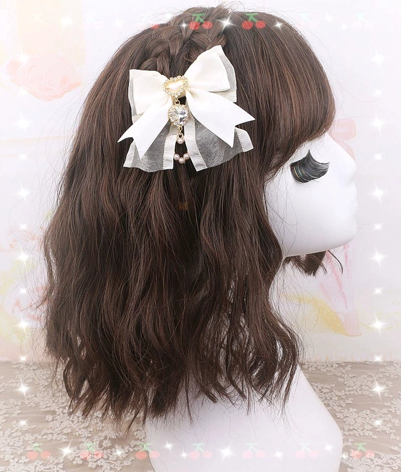 Beige-colored bow hair clip pair with heart rhinestone accents and pearl details for coordinated Jirai Kei styling