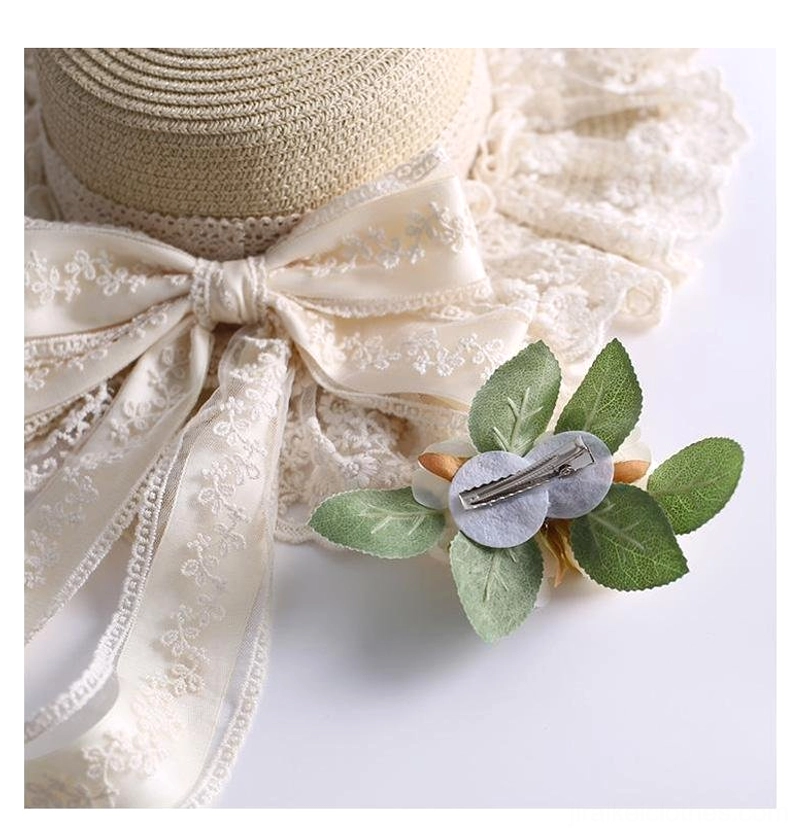 Beige country lolita straw sunhat detailed view of removable camellia clip and satin bow embellishment with lace trim jirai kei accessory