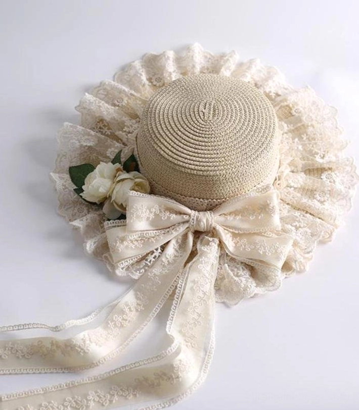 Beige country lolita straw sunhat flat lay top front view showing woven straw top ruffled lace brim bow with embroidered ribbons