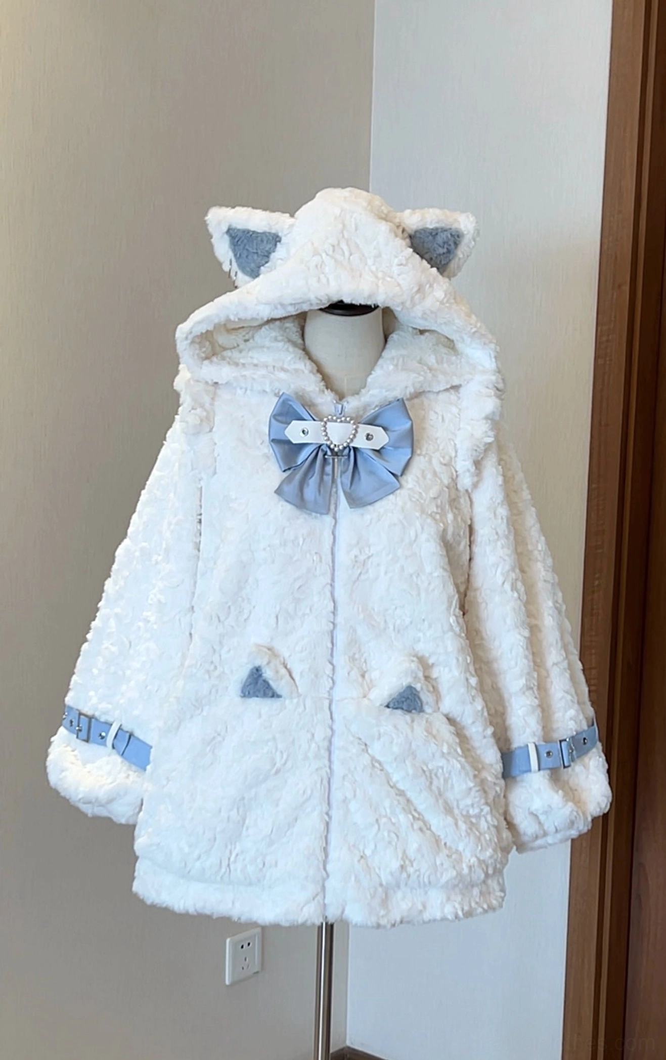 Light beige and light blue Jirai Kei fleece coat with light blue cat ear hood, blue bow decoration, and blue buckle strap cuffs, front display