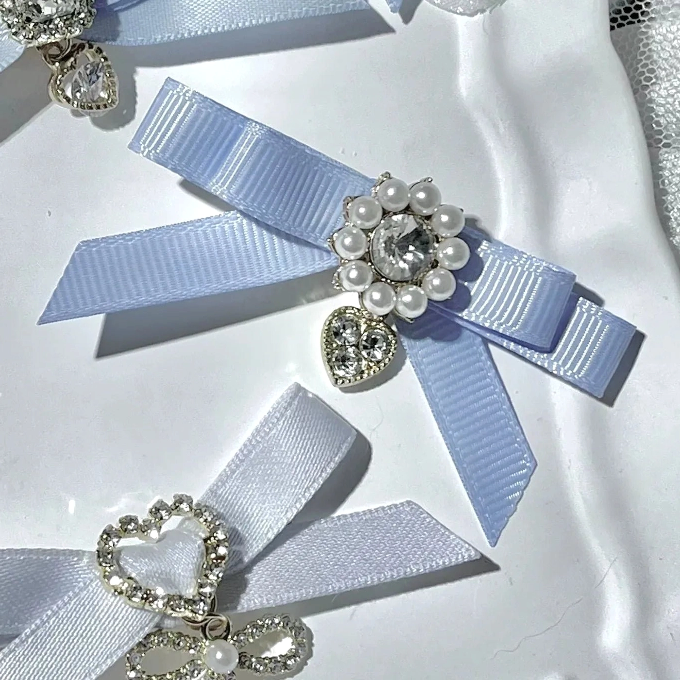 Black bow pendant hair clips Jirai Kei style with decorative hanging elements rhinestone embellishments and pearl details