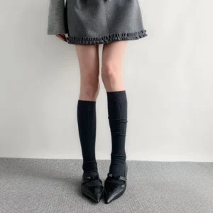 Black calf-length ribbed socks Jirai Kei style worn with ruffled grey skirt pointed flats