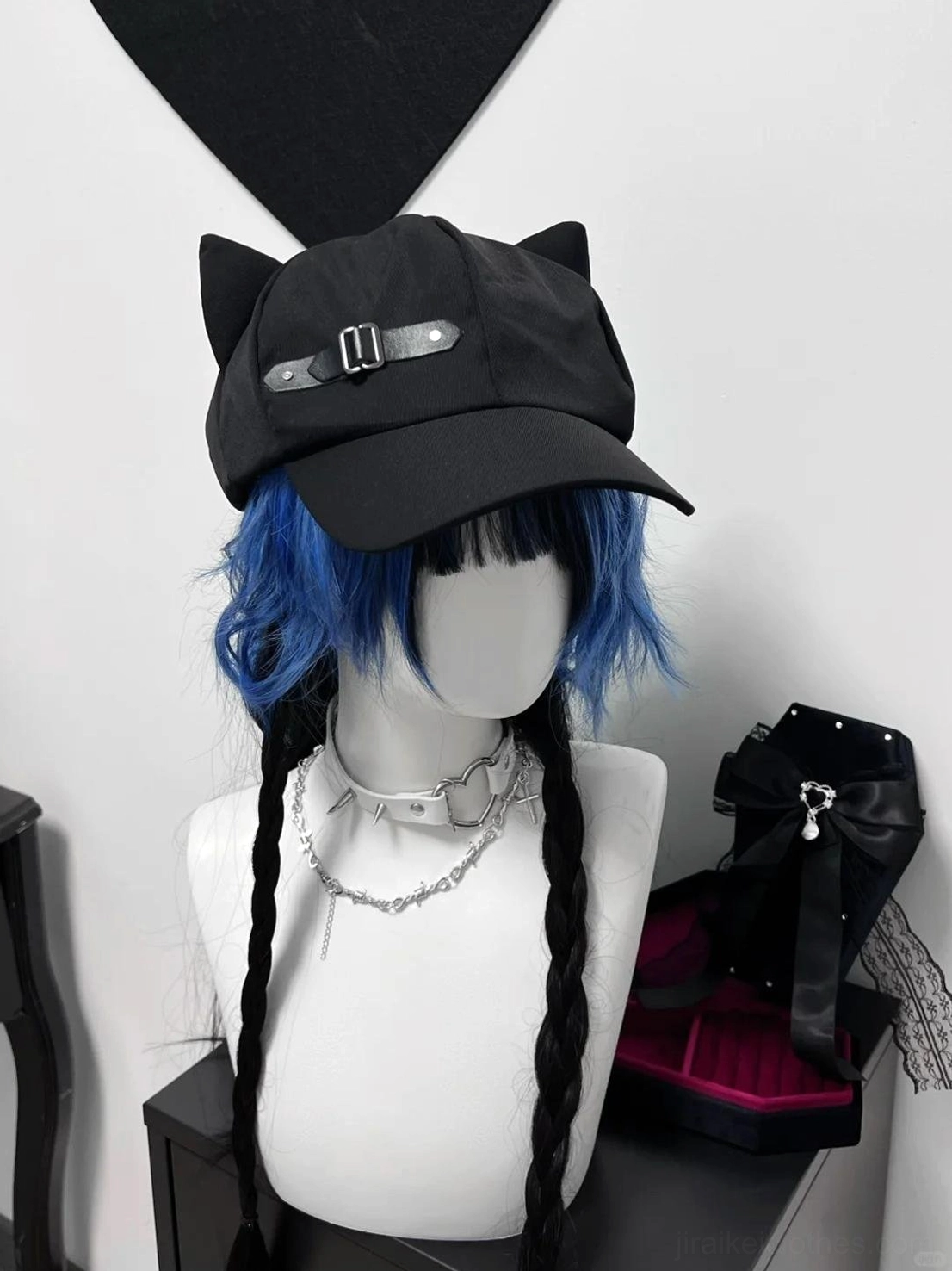 Black cat ear peaked cap front view on gothic mannequin with blue-black braided hair, leather buckle accent, dark academic fashion styling