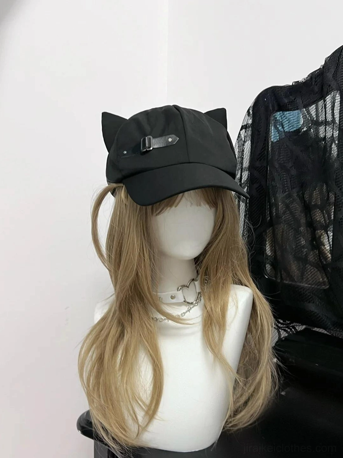 Black cat ear beret cap right side view, sleek design with leather buckle detail, golden curly hair mannequin, gothic fashion photography