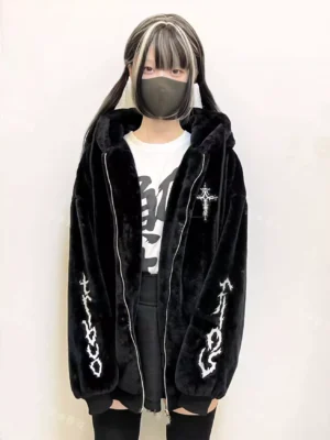 Black cat ear fleece hooded jacket with white gothic cross embroidery front view worn by model with oversized fit and dual zippers