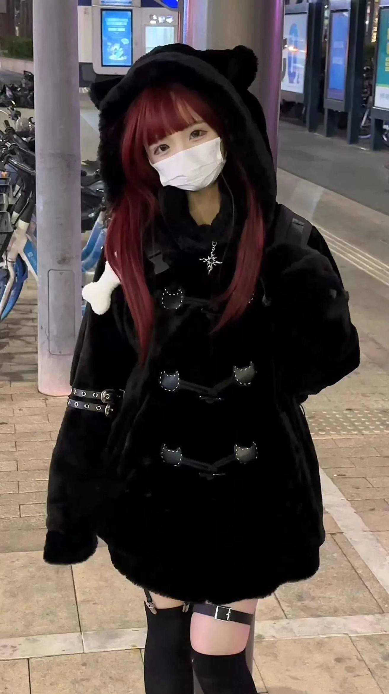 Black cat ear hooded jirai kei fuzzy winter coat front full view with red-haired model wearing face mask outdoor city street styling
