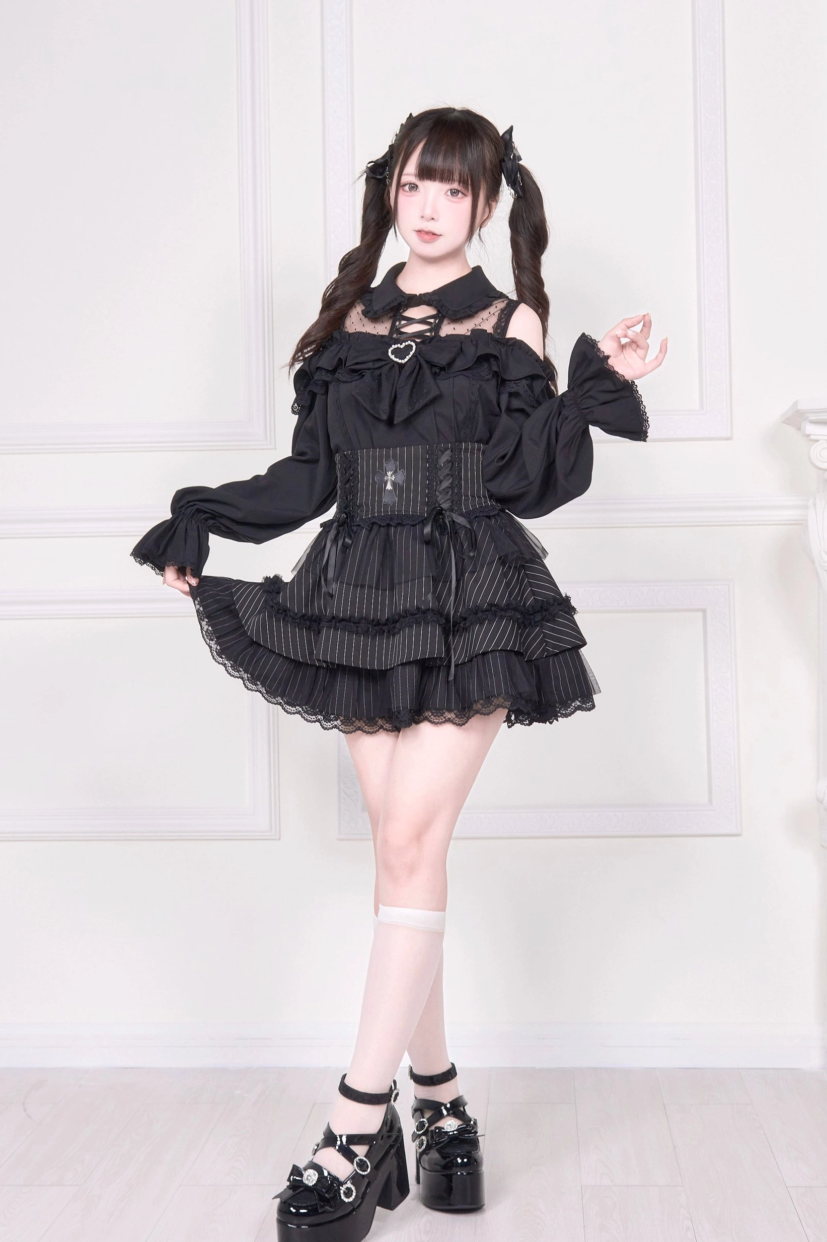 Black cold-shoulder Jirai Kei blouse back three-quarter view with layered ruffle skirt and platform shoes
