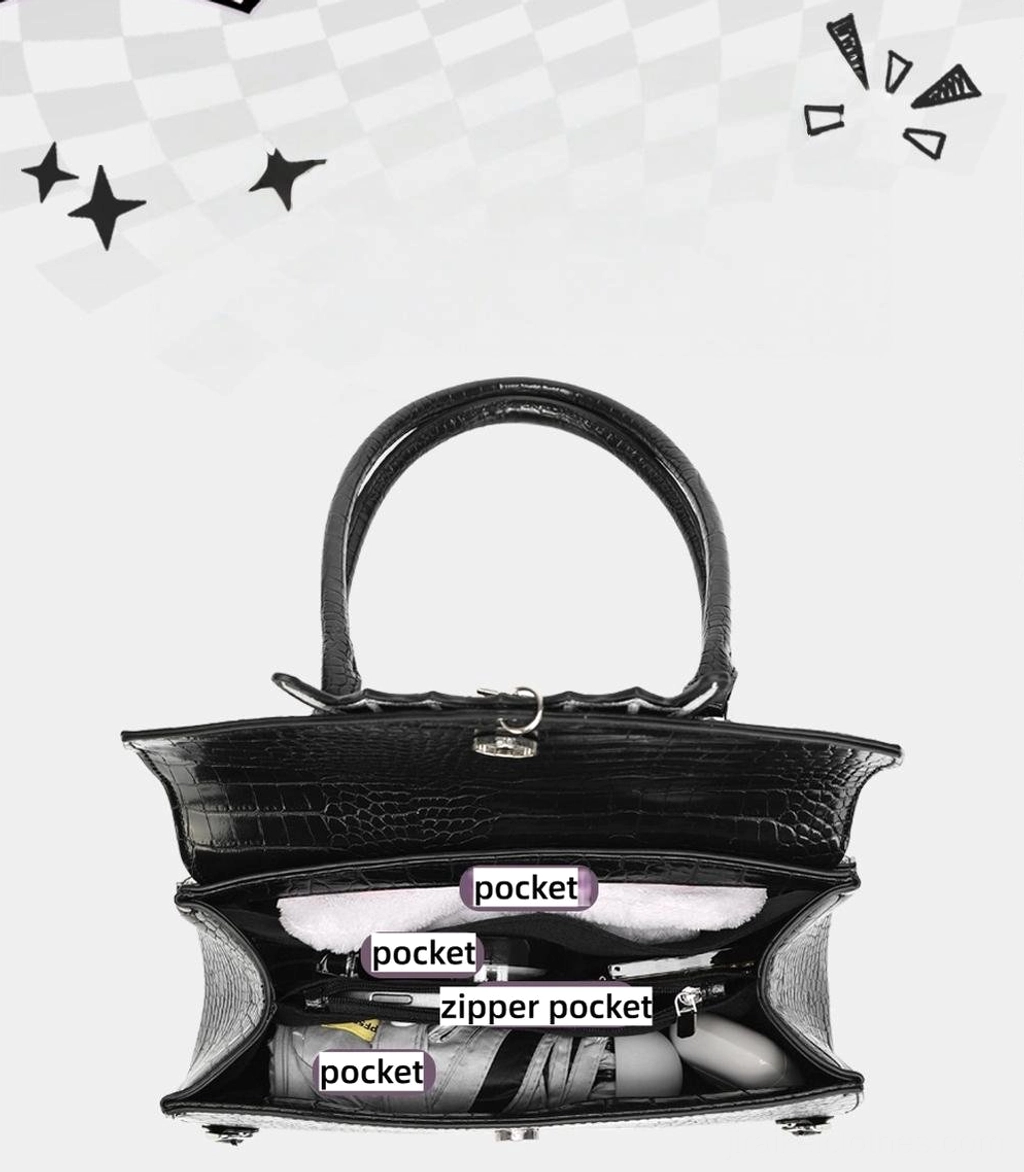 Black croc leather itabag rear open top view showing multiple internal pockets and lockable top closure in studio setting