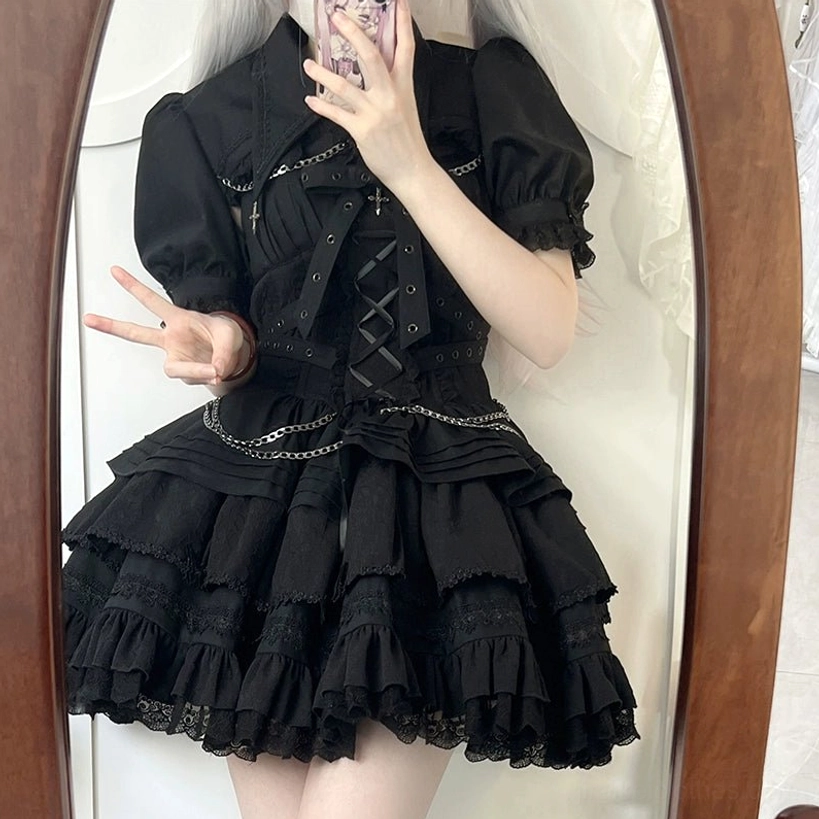 Black Gothic Lolita dress mirror selfie close-up showcasing puff sleeves lace-up corset chain trim details