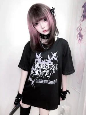 Black gothic oversized jirai kei t-shirt with stylized letter print front view female model bedroom aesthetic