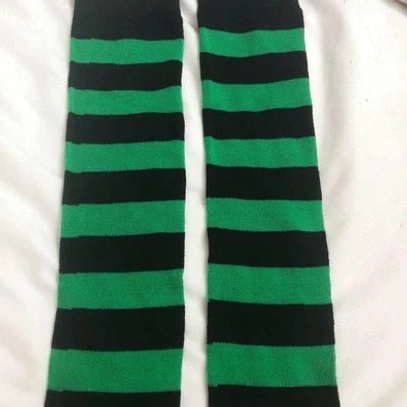 Black and green striped over-the-knee socks flat lay display, unique colorway horizontal stripe pattern, alternative fashion