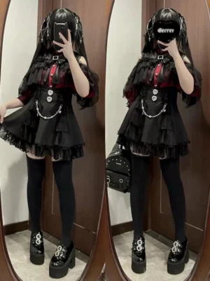 Gothic black tiered lace skirt with corset-style waist on twin goth girls wearing platform loafers, low-angle full-length mirror shot with crossbody bag accessory