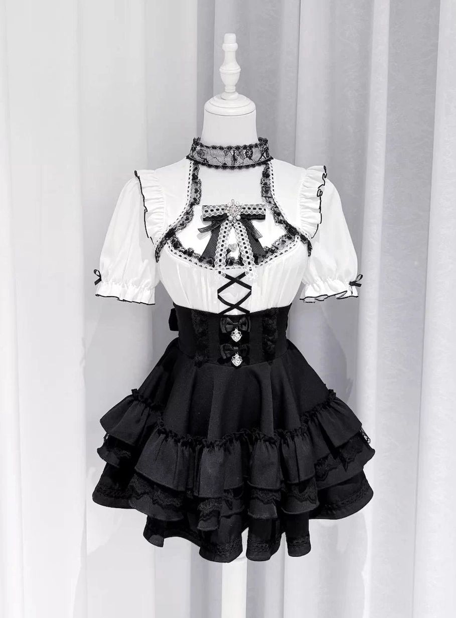 Black short puff sleeve Jirai Kei blouse with ruffled tiered black skirt on dress form front view