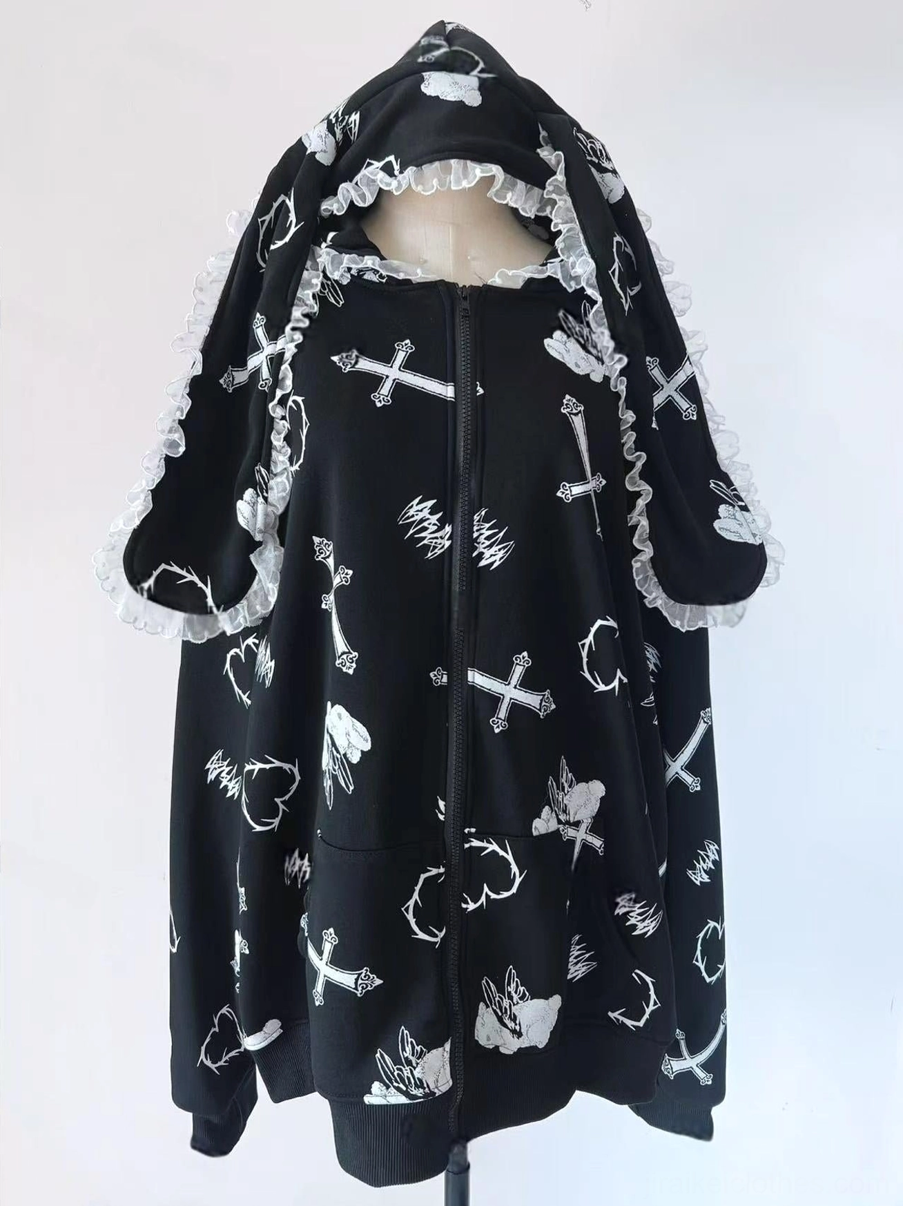 Black oversized Jirai Kei hoodie coat studio product photo, front full-view on white background showing lace-trim bunny ears, cross and heart prints, zip-up closure