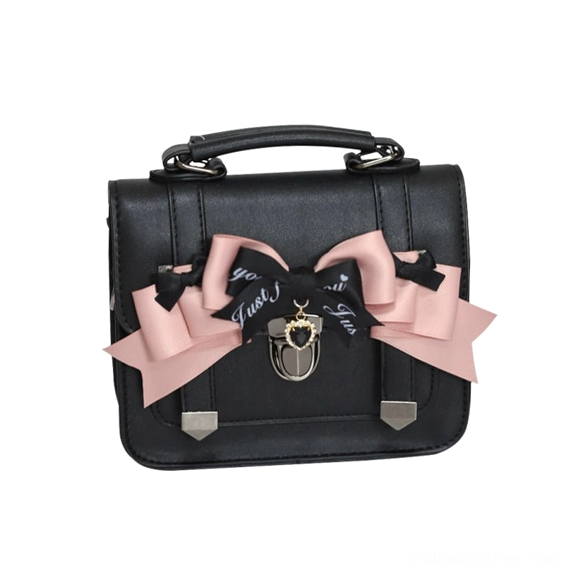 Black Jirai Kei Cambridge handbag with pink and black decorative bow featuring letter print detail and metal lock charm, flat lay product photography