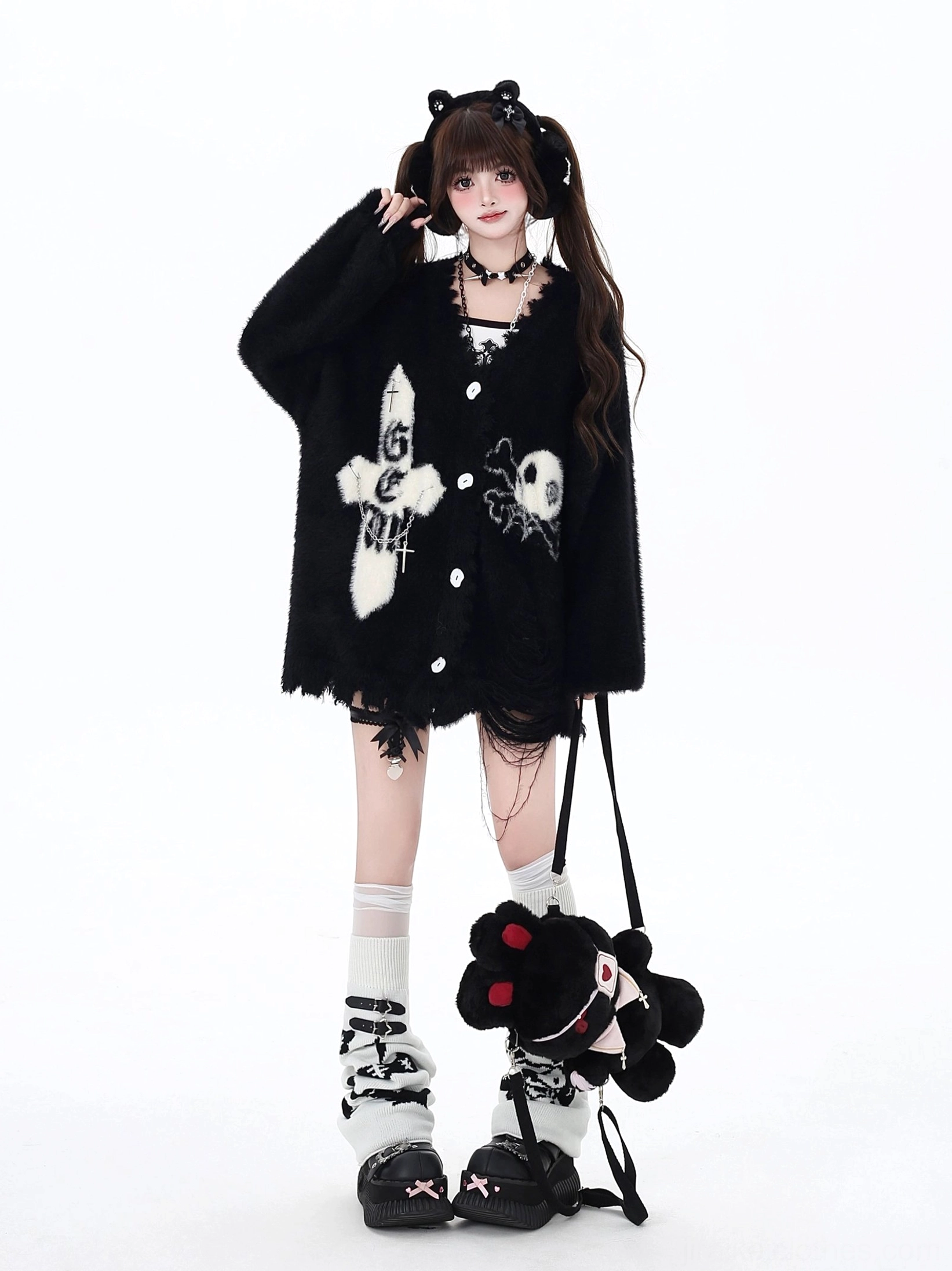 Black Jirai Kei distressed hem cardigan with cross and skull embroidered details, irregular frayed hemline, styled with matching choker accessory and twin-tail hairstyle