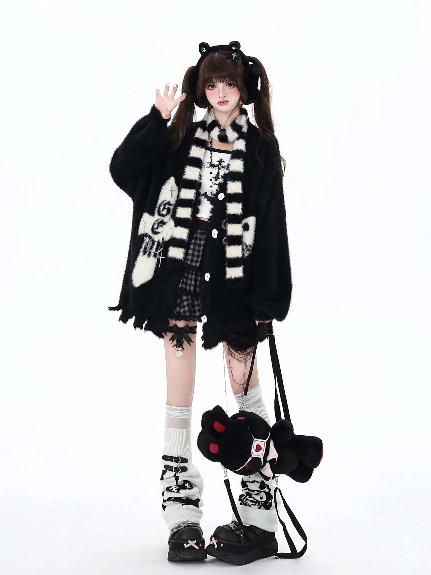 Black Jirai Kei irregular hem cardigan with frayed distressed hemline, embroidered cross and skull design, paired with matching striped scarf and plush crossbody bag accessory