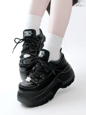 Black chunky platform jirai kei sneakers side view with white crew socks showing 7cm back platform heel height and metal toe ornament detail