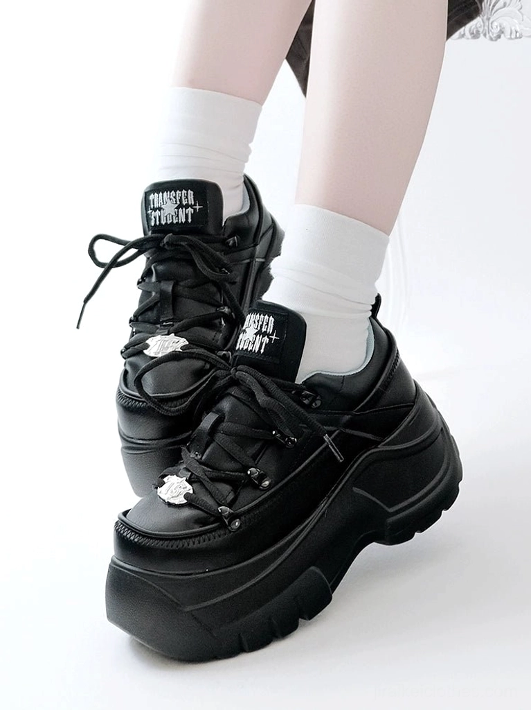 Black chunky platform jirai kei sneakers side view with white crew socks showing 7cm back platform heel height and metal toe ornament detail