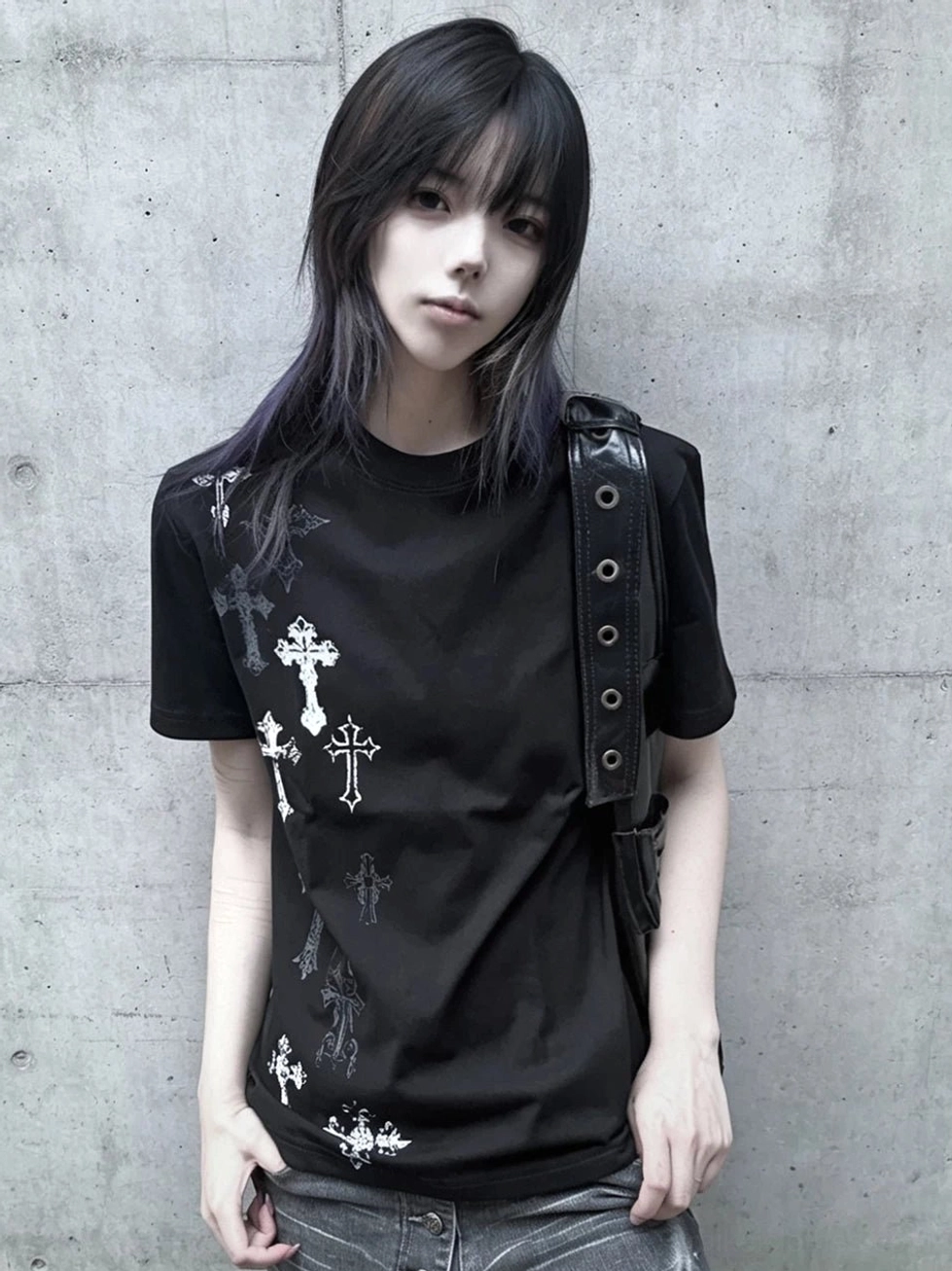 Black Jirai Kei cross print t-shirt with silver multiple style crosses on front, worn by female model against concrete wall, structured shoulders and crew neck design visible