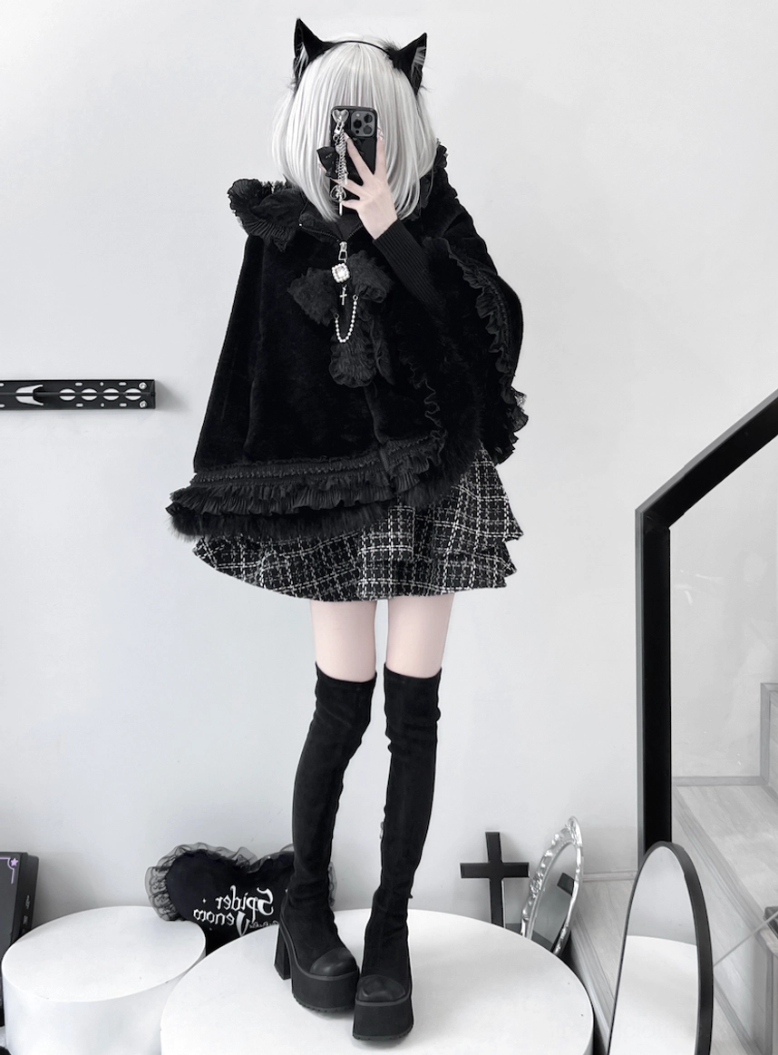 Mirror selfie of black cat ear fleece cape coat with lace hem, styled with plaid mini skirt and cat ear hair accessory in indoor setting