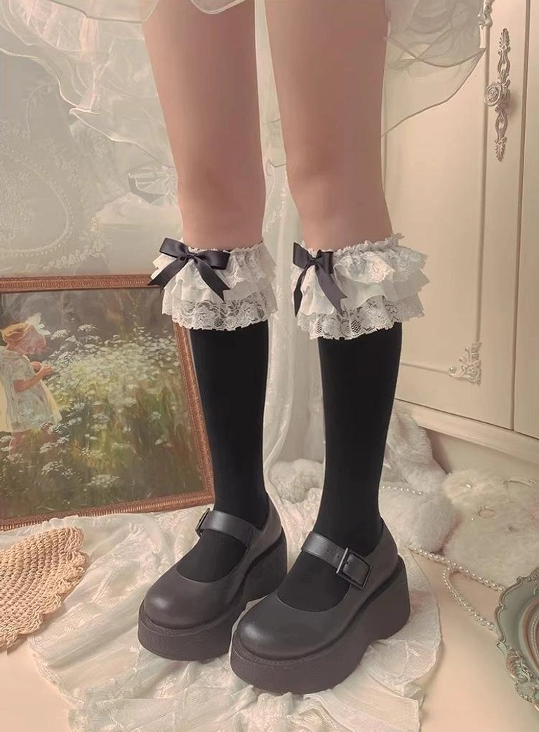 Black Jirai Kei frilled mid-calf socks with white ruffled lace cuff small black satin bow black platform Mary Jane shoes vintage interior straight front view