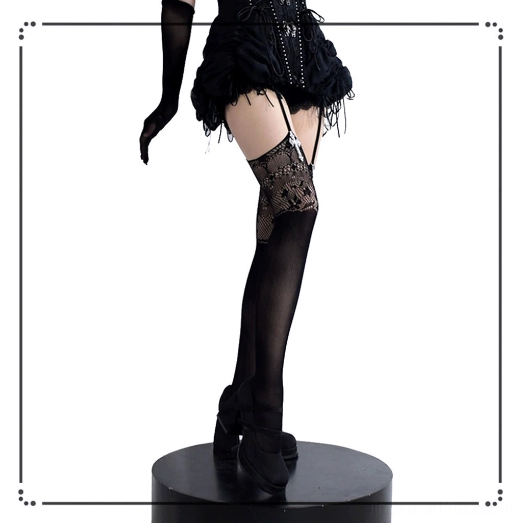 Single black gothic garter thigh-high stocking with cross pendant and lace cutout, product display on stand with black glove styling prop