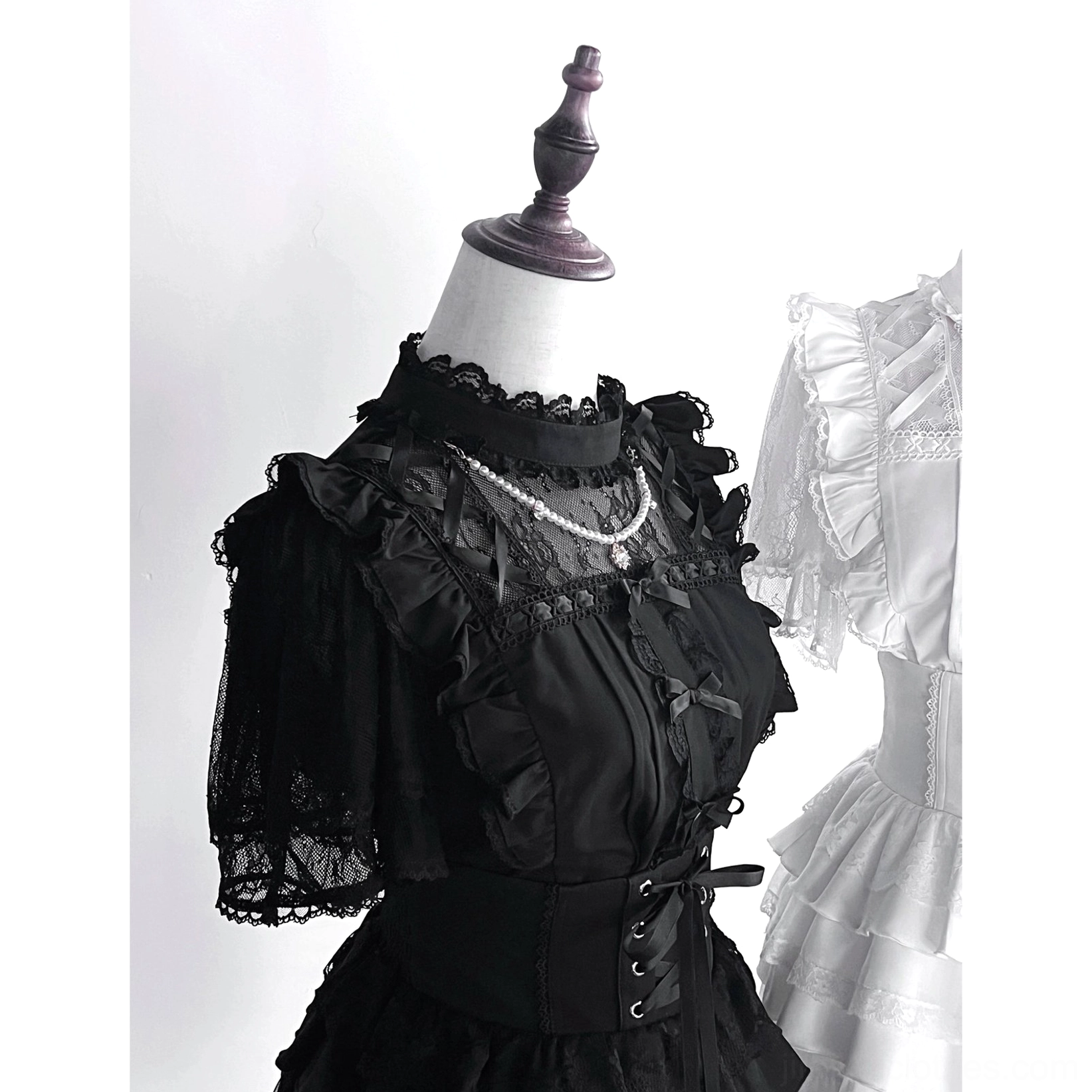 Black jirai kei gothic lolita blouse standalone detail showing lace short sleeves corset waist construction and romantic subculture fashion elements
