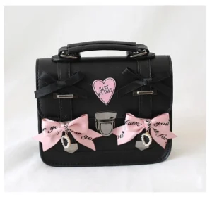 Black Jirai Kei heart bow leather shoulder bag with pink printed bows and rhinestone pendant front flat lay view