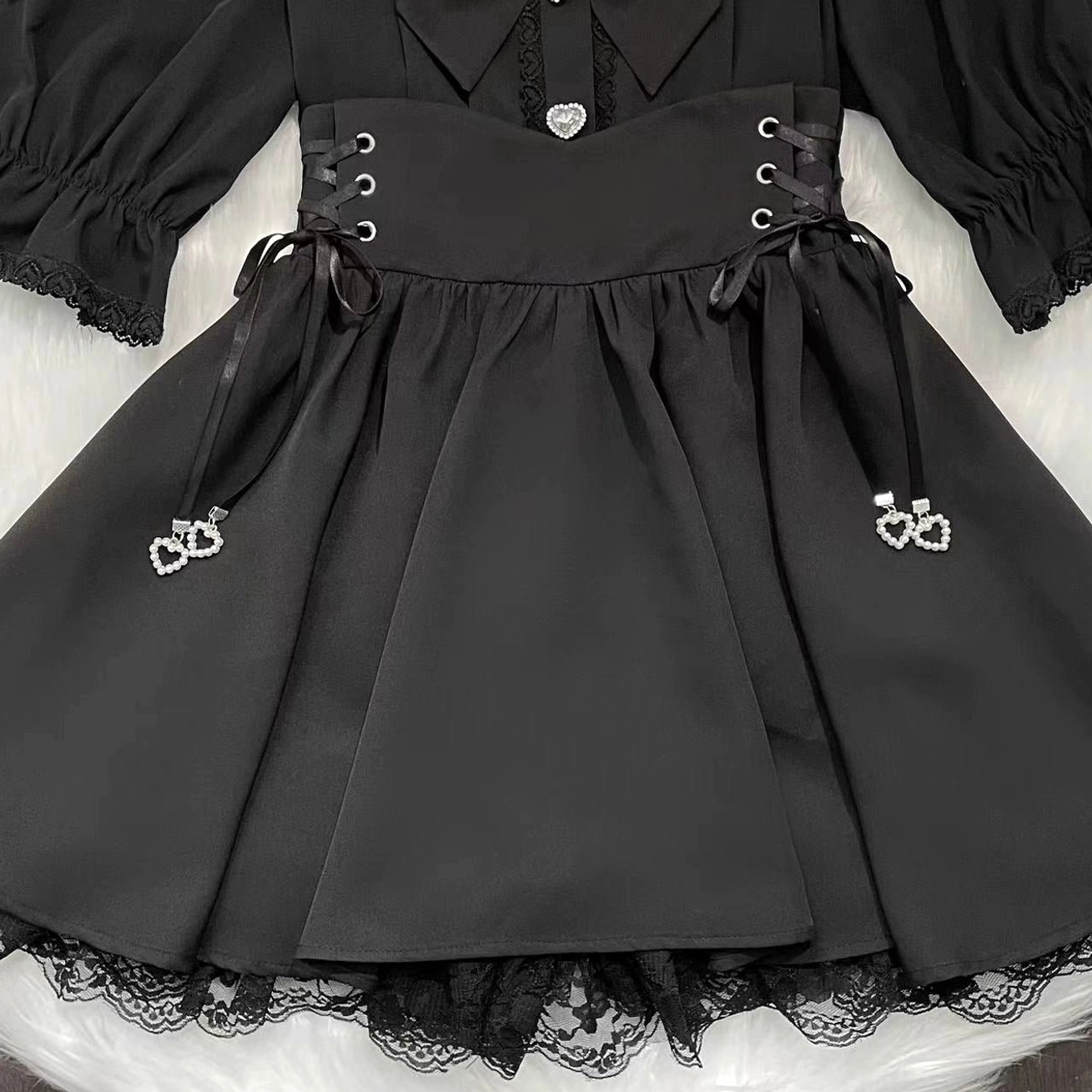Black high-waisted Jirai Kei skirt with flounce hem lace trim, pearl heart pendant charm, elastic waistband, and built-in shorts - standalone skirt styling for jirai kei fashion ensemble