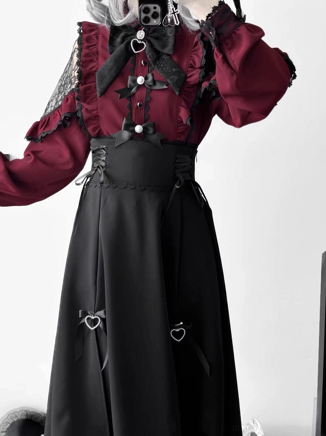 Black jirai kei high-waist skirt side lace-up detail heart bow trims half body view plain white background