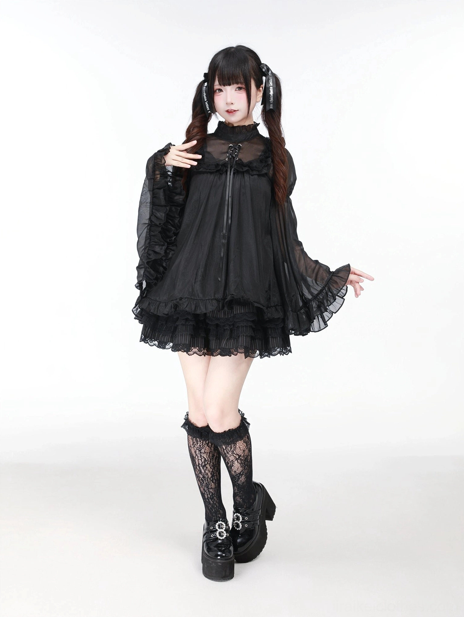 Black Jirai Kei jumper dress with hime-sleeved sheer blouse front view studio shot showing square neckline and ruffled bishop sleeves